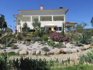a house with a garden in front of it at Casa Gaia in Serpins