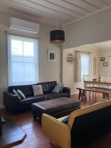 a living room with a couch and a table at City oasis in Gisborne