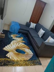 a blue couch sitting in a living room at Bnb kamakis in Ruiru