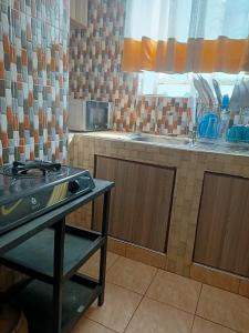 a kitchen with a stove and a counter top at Bnb kamakis in Ruiru