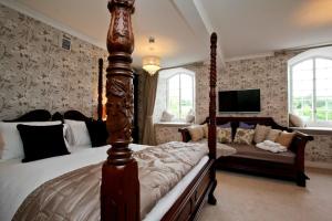 a bedroom with a bed and a couch in it at Notley Arms Inn Exmoor National Park in Elworthy