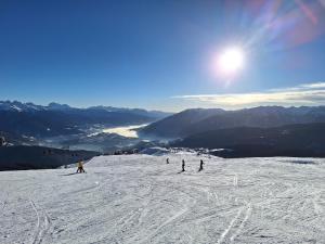 a group of people skiing down a snow covered slope at Residence Rastbichl - Apartments & Indoor-Pool in Maranza