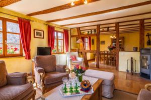 a living room with a table with flowers on it at Maison Gîte Au Tonnelier in Hunawihr