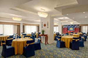 a banquet room with tables and chairs and chandeliers at Days Inn by Wyndham Gangtok Tadong in Gangtok