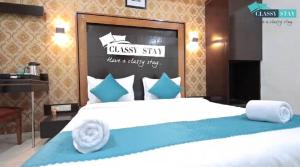 a bedroom with a large bed with blue and white pillows at Manas Residency Classy Stay in Mumbai