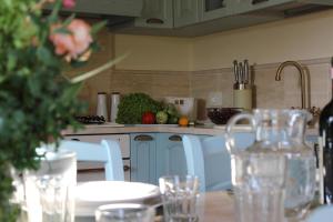 a kitchen with a table with chairs and a counter top at Torre Di Sant'Ansano in Corsano
