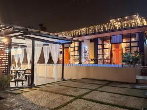 a house at night with a table and chairs at Casa nel Mezzo - A Pineapple Farm Escapee in Ulot