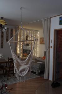 a hammock hanging in a living room with lights at Lumiére in Warsaw