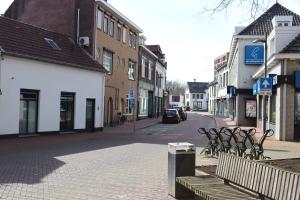 a street in a town with benches and buildings at B&B 't Morregaât in Weert
