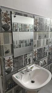 a bathroom with a sink and a mirror at JSK Resort in Mirissa