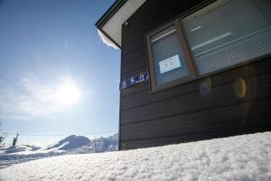 un bâtiment avec une fenêtre dans la neige dans l'établissement Starry Sky Cottage 17, à Bihoro 56 autres photos