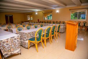 a group of tables and chairs in a room at Malava-K-Resort in Kakamega +113 photos