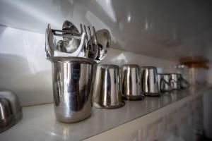 a group of silver utensils sitting on a counter at HRBR Enclave one BHK with fully furnished in Bengaluru