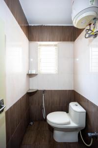 a small bathroom with a toilet and a window at HRBR Enclave one BHK with fully furnished in Bengaluru