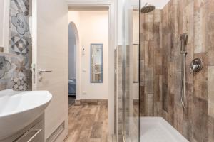 a bathroom with a sink and a shower at Casavacanzefranca - 12 in Terrasini