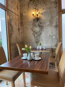 a dining room table with chairs and a chandelier at Hotel Centro in Schwabach