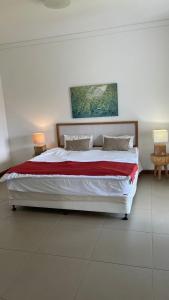 a bedroom with a large bed with two lamps at Azuri Mauritius Penthouse with Sea Views in Rivière du Rempart