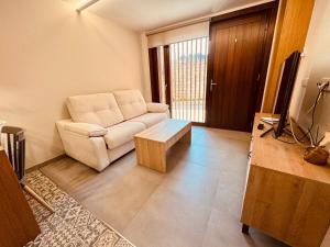 a living room with a couch and a coffee table at Casa a Xanela Azul in Celanova