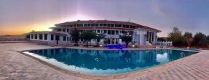 a house with a swimming pool in front of a building at Amrouss touristic DarMaroc in Azrou