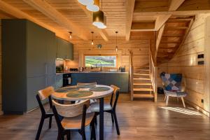 a kitchen and dining room with a table and chairs at zDrzewaDom in Skrzydlna