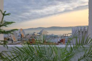 a view of a harbor with a cruise ship in the water at Dar Tanjawiya in Tangier