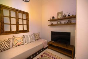 a living room with a couch and a fireplace at Dar Tanjawiya in Tangier