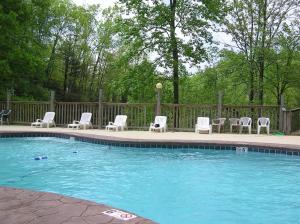 a swimming pool with chairs and a group at Pooling Around #200 in Gatlinburg