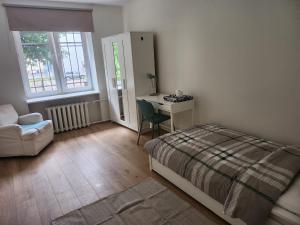 a bedroom with a bed and a desk and a chair at Peaceful Room in Shared Flat Close to Old Town in Tallinn