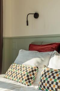 a bed with two pillows and a lamp on the wall at Cozy Apartment with Balcony near Old Town Gdańsk by Rent like home in Gdańsk +13 photos