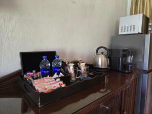 a tray of food and drinks on a table next to a refrigerator at Lakeside 12 in Dullstroom