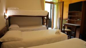 Postel nebo postele na pokoji v ubytování Hotel Davost