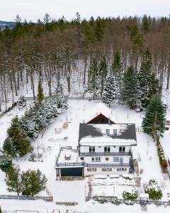 an aerial view of a house in the snow at Heart of Polen appartements in Piechowice