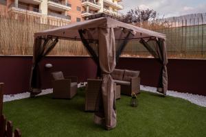 a gazebo with a couch and chairs under it at Fiera & Airport-Suite Leonardo Relax- Garden & wi-fi free in Fiumicino Airport