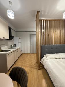 a bedroom with a bed and a kitchen with a counter at Green door in Kolomiya