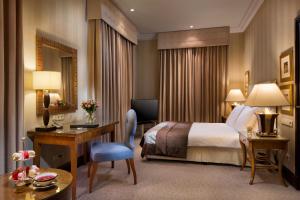 a hotel room with a bed and a desk at Esplanade Zagreb Hotel in Zagreb