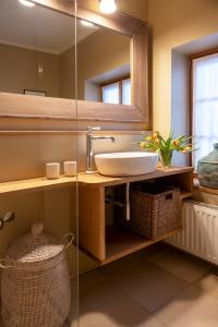 a bathroom with a sink and a mirror at Temelhof - Landhaus mit Sauna und Kamin in Sittersdorf +45 photos
