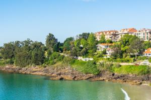a view of a river with houses on a hill at Apartamentos Punta Lucero en Portonovo in Portonovo