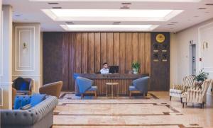 a person sitting at a table with a laptop at The Yalı Konak Hotel İzmir in İzmir