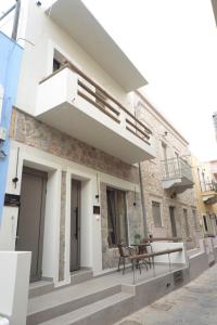 a facade of a house with a balcony at To Stenaki Apartments in Kalymnos