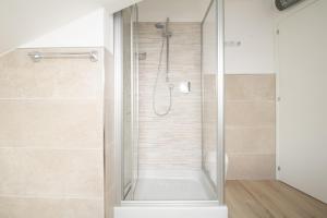 a shower with a glass door in a bathroom at Balcone sul Mare Wi-Fi Aria condizionata in Porto San Giorgio +14 photos