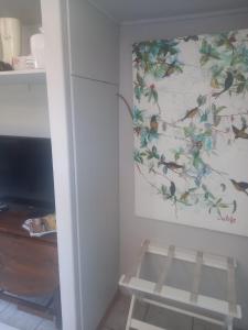a room with a wall with a painting on the wall at Den-Away Guesthouse Self Catering Middelburg Mpumalanga in Mhluzi +9 photos