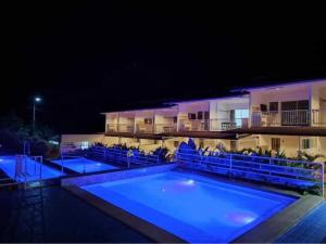 a swimming pool with blue lighting in front of a building at DMC Condotel in Puerto Princesa City