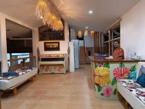a man standing at a counter in a room with beds at DMC Condotel in Puerto Princesa City