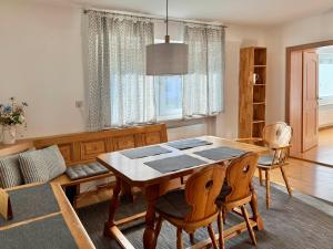 a dining room with a wooden table and chairs at Ferienwohnung Gartenblick in Amerang