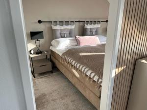 a bedroom with a bed and a table with a lamp at Ostsee-AuszeitDahme in Dahme
