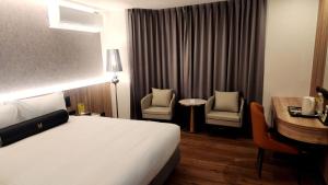 Voodi või voodid majutusasutuse Jiati Business Motel toas