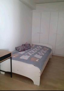 a small bedroom with a bed and a desk at Stylish city center home with sauna in Rovaniemi