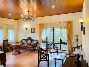 a living room with a table and chairs at Gee Hills in Weligama