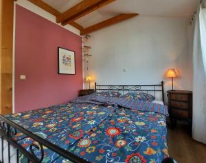 a bedroom with a bed with a colorful comforter at Ferienwohnungen "Vieling" Objekt-ID 12155-9 in Waren +32 photos