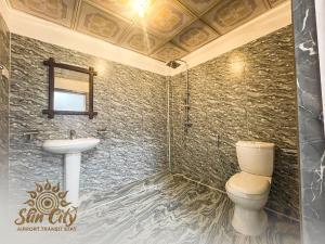 a bathroom with a toilet and a sink at SunCity Airport Transit Stay in Minuwangoda